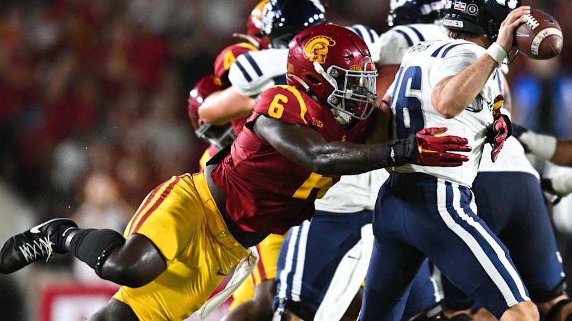 Sep 7, 2024; Los Angeles, California, USA; USC Trojans defensive end Anthony Lucas (6) attempts to sack Utah State Aggies quarterback Bryson Barnes (16) during the second quarter at United Airlines Field at Los Angeles Memorial Coliseum. Mandatory Credit: Jonathan Hui-Imagn Images | Jonathan Hui-Imagn Images 