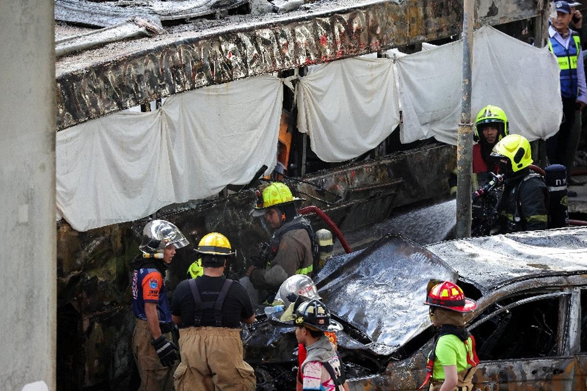 Emergency services work at a site where a train collided with a bus and several cars on Asok-Din Daeng Road, causing several casualties, in Bangkok, Thailand, May 16, 2026. REUTERS/Athit Perawongmetha