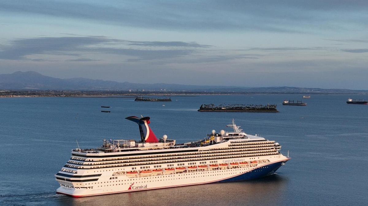 Long Beach, CA - February 17: An aerial view of the Carnival Radiance, a Destiny-class cruise ship, as it heads out to sea in Long Beach at sunset Friday, Feb. 17, 2023. (Allen J. Schaben / Los Angeles Times)