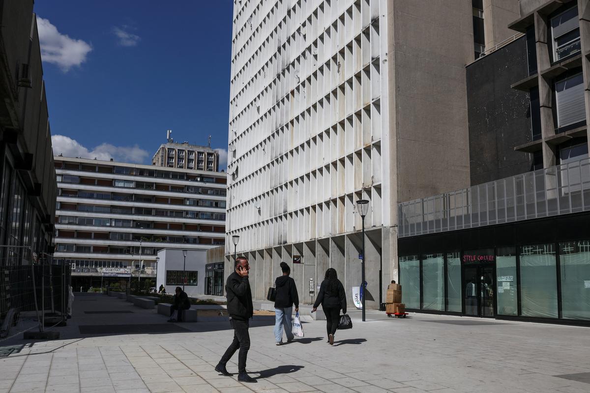 People walk near a market in the Paris suburb of Sarcelles, France, April 14, 2026. REUTERS/Tom Nicholson