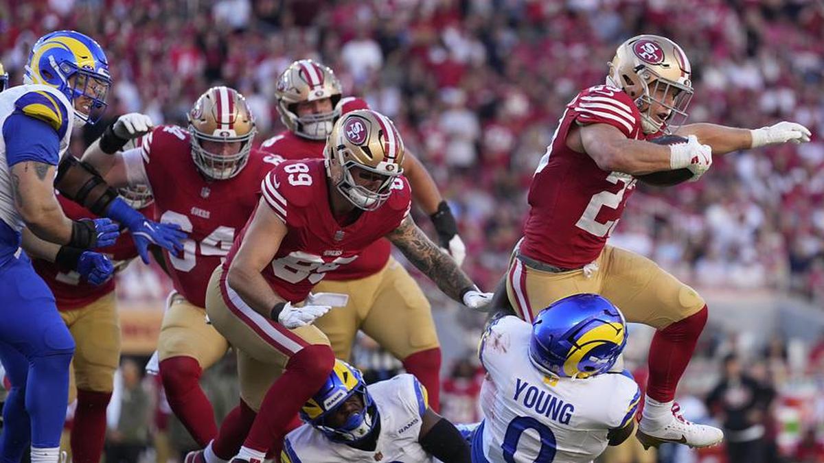  Nov 9, 2025; Santa Clara, California, USA; San Francisco 49ers running back Christian McCaffrey (23) runs the ball against Los Angeles Rams linebacker Byron Young (0) during the second quarter at Levi's Stadium. Mandatory Credit: Kyle Terada-Imagn Images | Kyle Terada-Imagn Images 