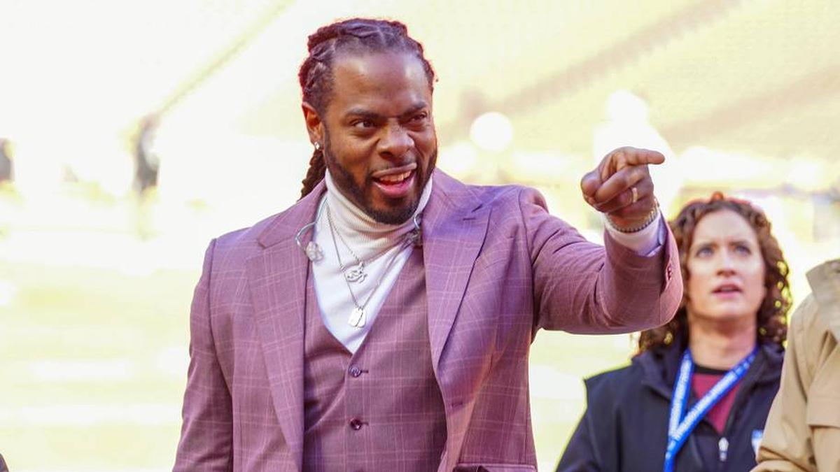  Nov 29, 2024; Kansas City, Missouri, USA; Commentator Richard Sherman signals to fans prior to a game between the Kansas City Chiefs and Las Vegas Raiders at GEHA Field at Arrowhead Stadium. Mandatory Credit: Denny Medley-Imagn Images | Denny Medley-Imagn Images 