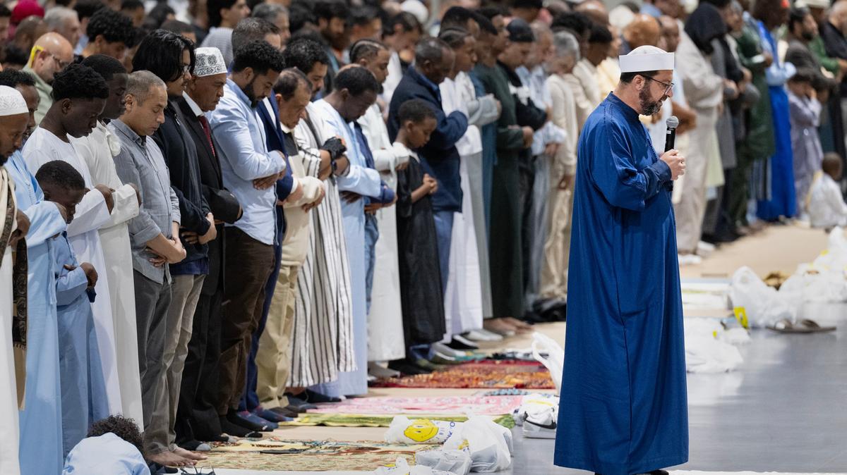Imam Taha Hassane of the Islamic Center of San Diego leads community members in prayer during the Islamic holiday Eid al-Adha at the San Diego Convention Center on May 27, 2026, in San Diego. The community is coming together to heal during the "Festival of Sacrifice" nine days after the Islamic Center of San Diego was the target of a shooting. (Luke Johnson/The San Diego Union-Tribune/TNS)