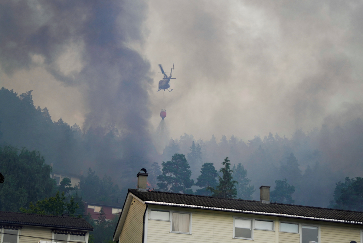 Smoke rises from a large fire that has spread from terraced houses in Krokstadelva, Drammen municipality, Norway, July 17, 2026. More than 50 homes were destroyed by fire on Friday near the city of Drammen in southern Norway as firefighters battled to contain the flames amid strong winds, rescue officials said. Thomas Fure/NTB/via REUTERS
