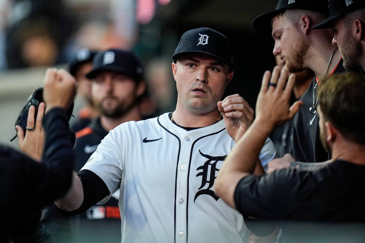  Detroit Tigers pitcher Tarik Skubal high-fives teammates in the dugout. 