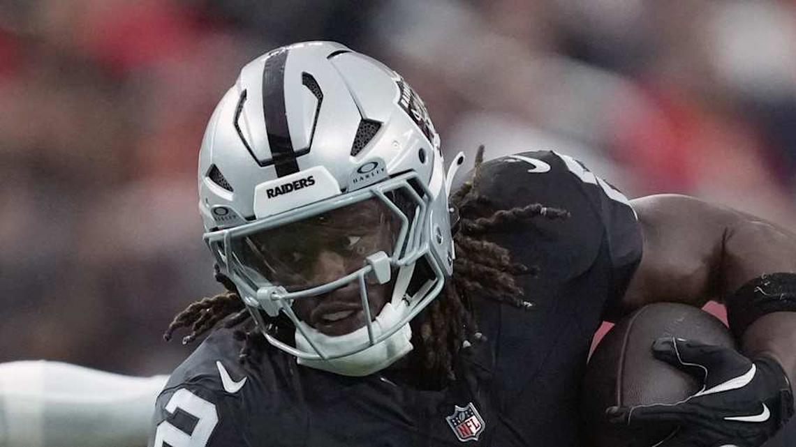  Jan 4, 2026; Paradise, Nevada, USA; Las Vegas Raiders running back Ashton Jeanty (2) carries the ball against Kansas City Chiefs linebacker Drue Tranquill (23) in the first half at Allegiant Stadium. Mandatory Credit: Kirby Lee-Imagn Images | Kirby Lee-Imagn Images 