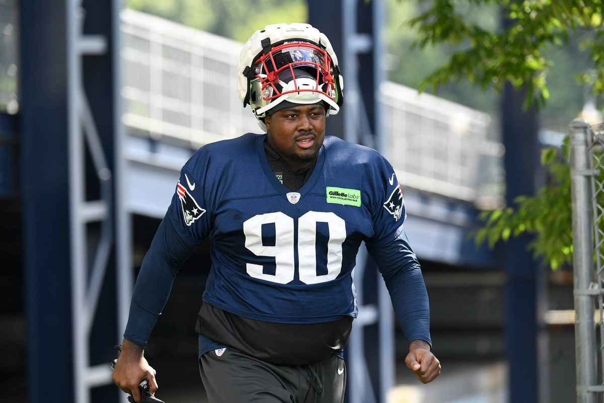  New England Patriots defensive end Christian Barmore (90) walks to the practice field at the Patriots training camp at Gillette Stadium. Eric Canha-Imagn Images 