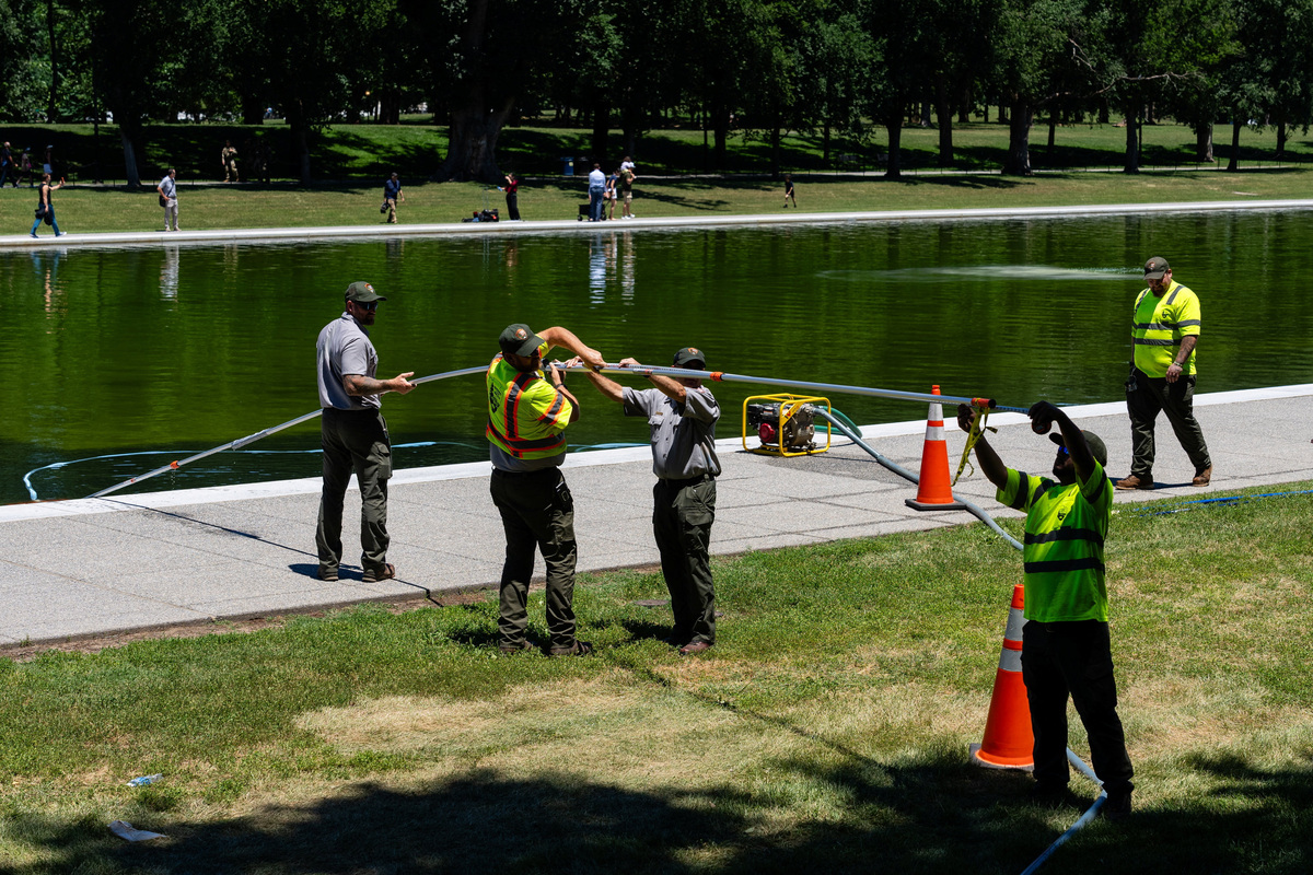U.S. National Park Service workers clean algae from the Lincoln Memorial Reflecting Pool, after recent renovations following a directive from U.S. President Donald Trump to paint it blue ahead of the 250th anniversary of U.S. Independence, in Washington, D.C., U.S., June 16, 2026. REUTERS/Eric Lee