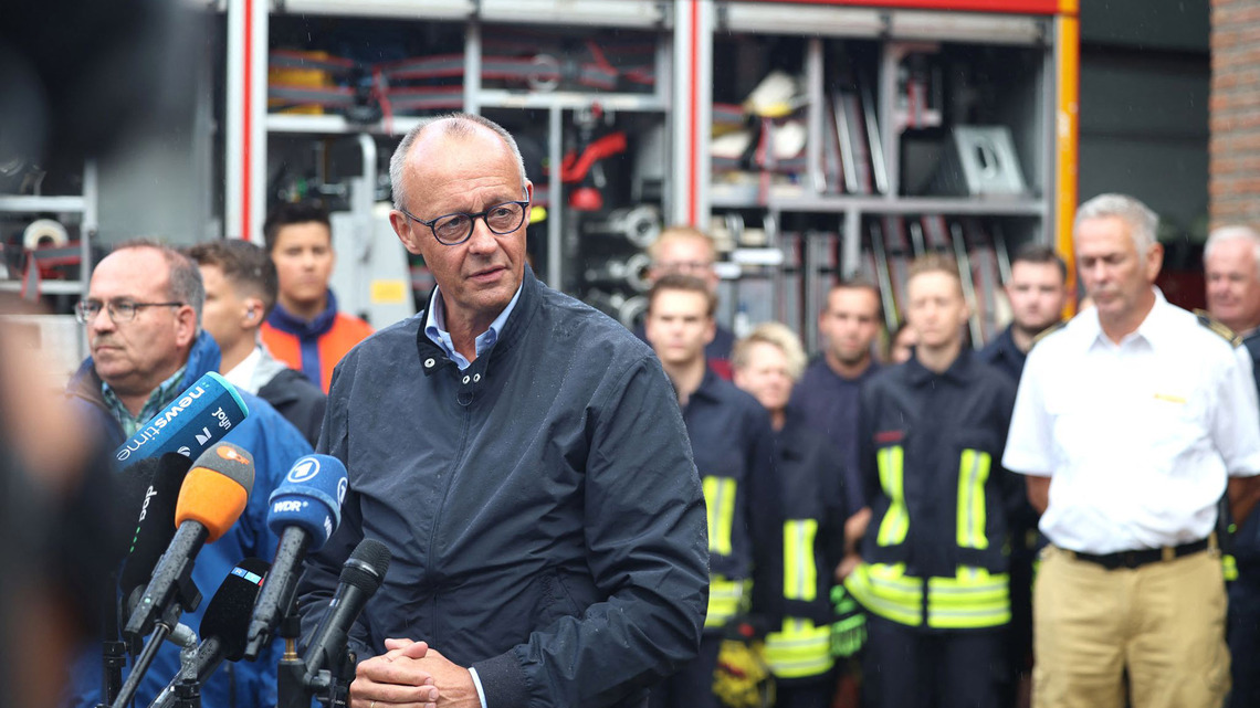 Merz faces down protesters at burnt forest as he thanks fire crews 