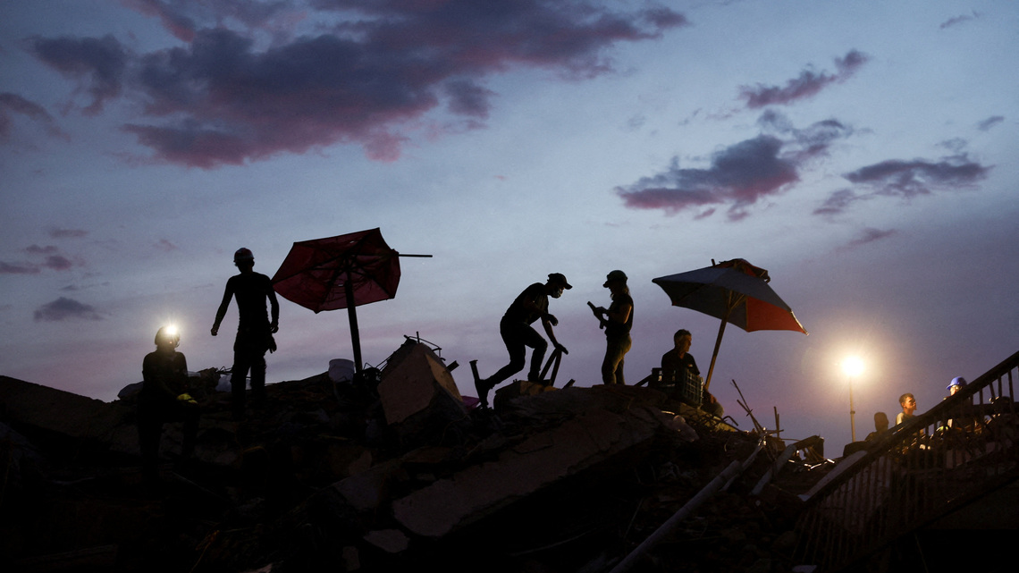 Between silence and shouts, rescuers dig for Venezuela twin quake survivors 