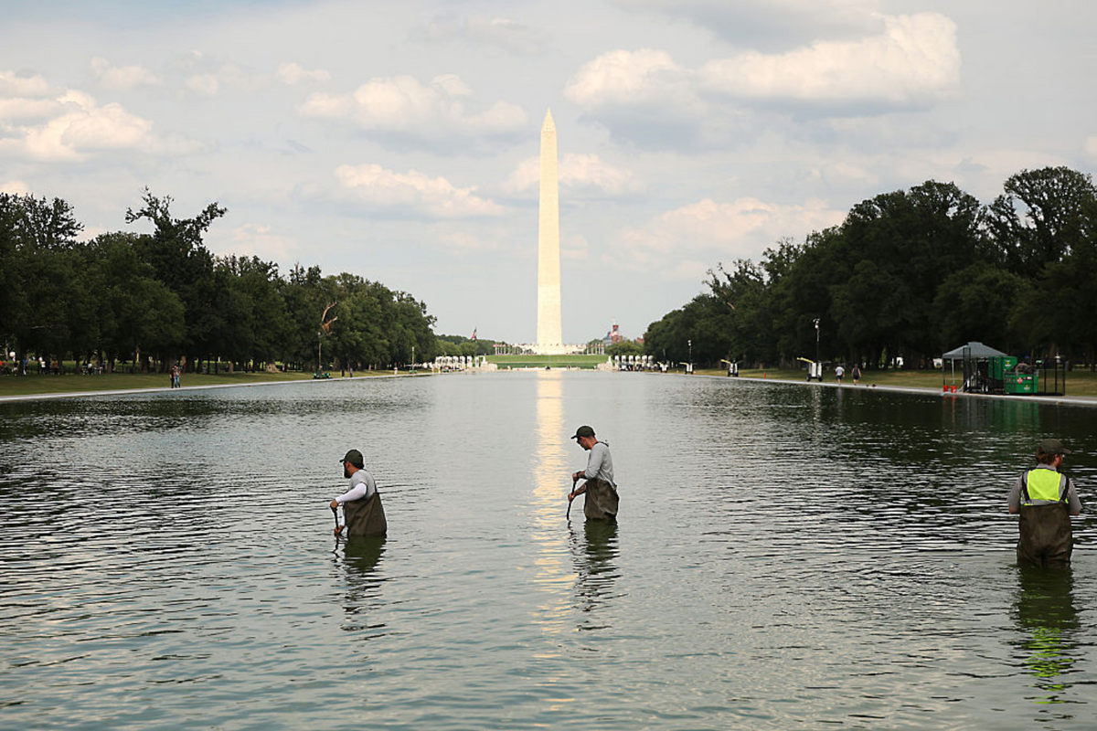  National Park Service employees work to clean up algae in the Lincoln Memorial Reflecting Pool following the completion of recent renovations, on June 14, 2026, in Washington. 