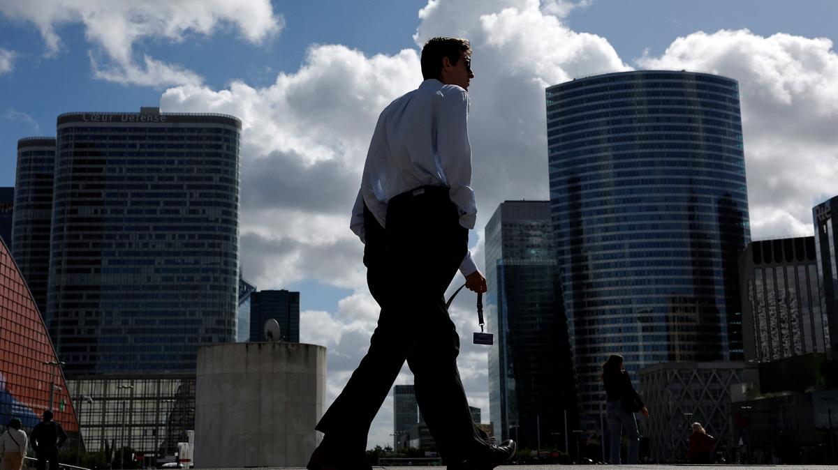 People walk past the skyscrapers of the financial and business district of La Defense in Puteaux near Paris, france, September 12, 2025. REUTERS/Stephanie Lecocq