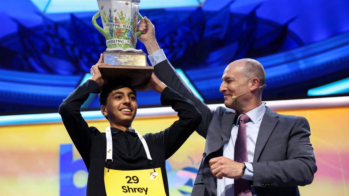 Shrey Parikh lifts the trophy after winning the annual Scripps National Spelling Bee with "cashaw" as his winning word in Washington, D.C., U.S., May 28, 2026. REUTERS/Kevin Lamarque