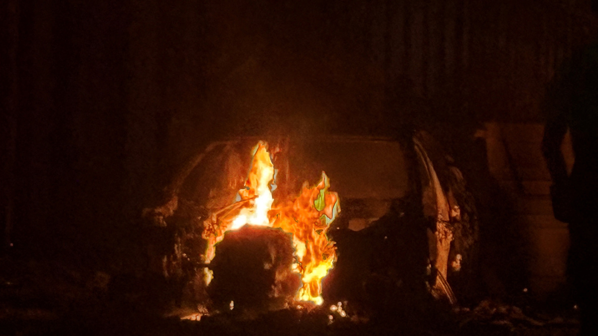 A car burns in east Belfast, during a protest after a knife attack on June 8 left a man seriously injured and prompted police to declare a critical incident, in Belfast, Northern Ireland, June 9, 2026. Picture taken wih a phone. REUTERS/Isabel Infantes