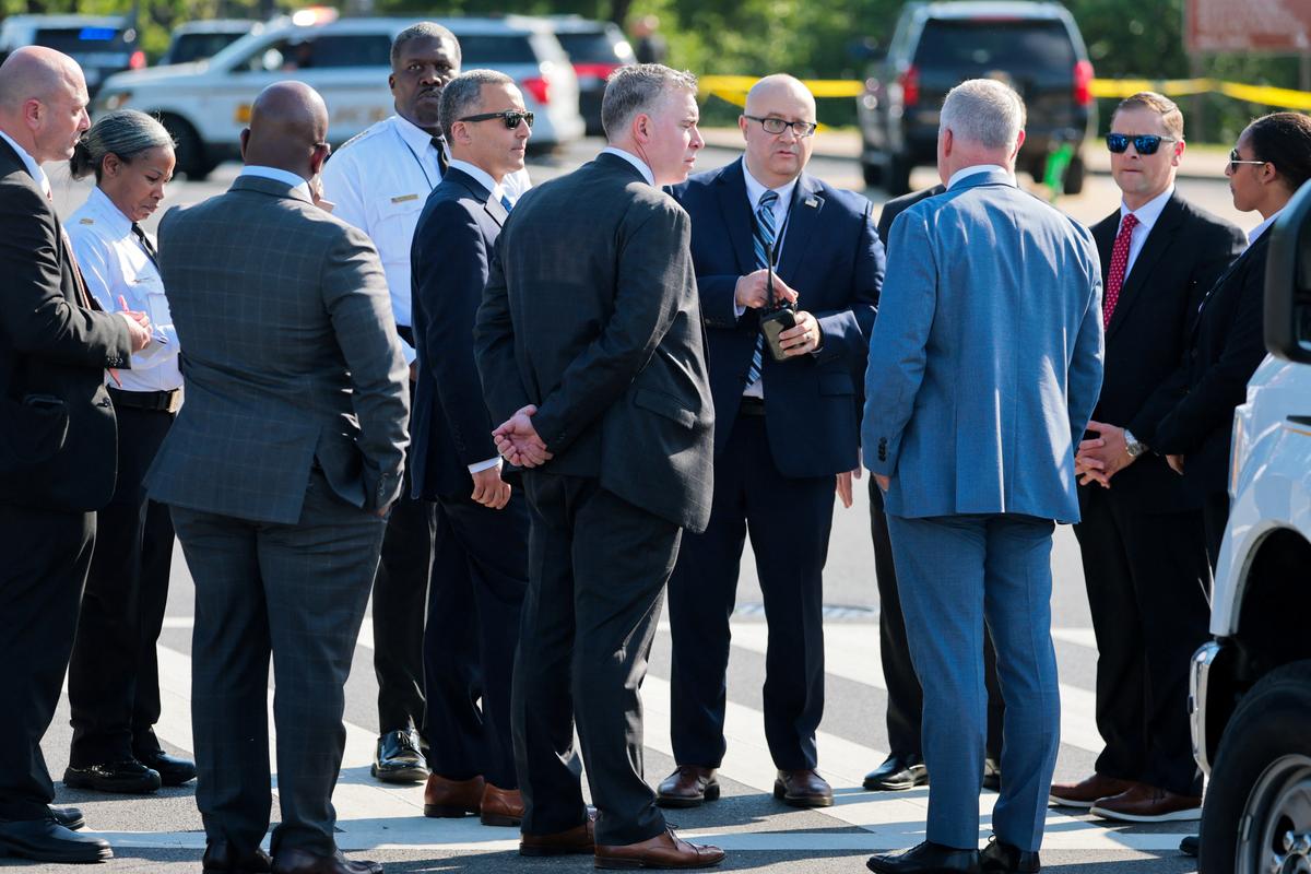 U.S. Secret Service personnel and police officers gather near the scene of an officer-involved shooting in Washington, D.C., U.S., May 4, 2026. REUTERS/Jonathan Ernst