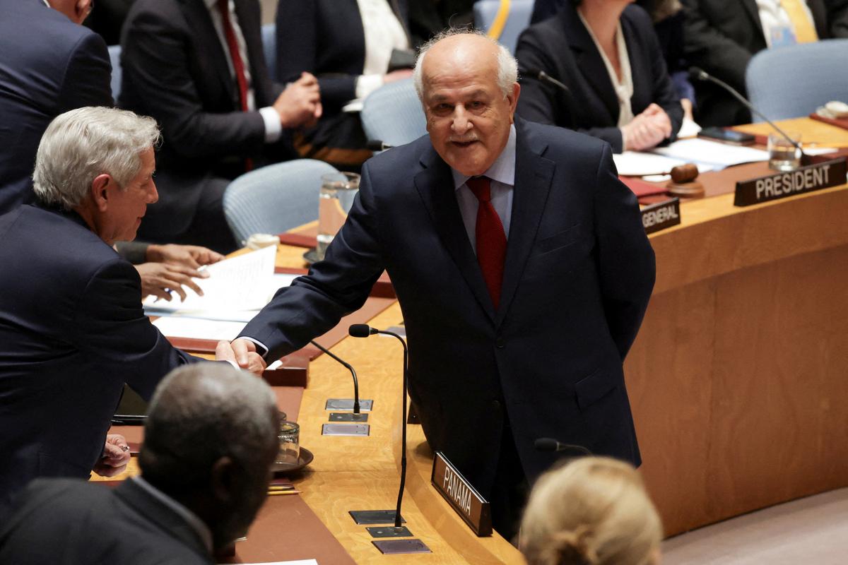 FILE PHOTO: Riyad H. Mansour, Palestinian Permanent Observer to the United Nations, shakes hands with Eloy Alfaro de Alba, Permanent Representative of Panama to the UN, before a Security Council meeting on the situation in the Middle East, at U.N. headquarters in New York City, U.S., February 18, 2026. REUTERS/Jeenah Moon/File Photo