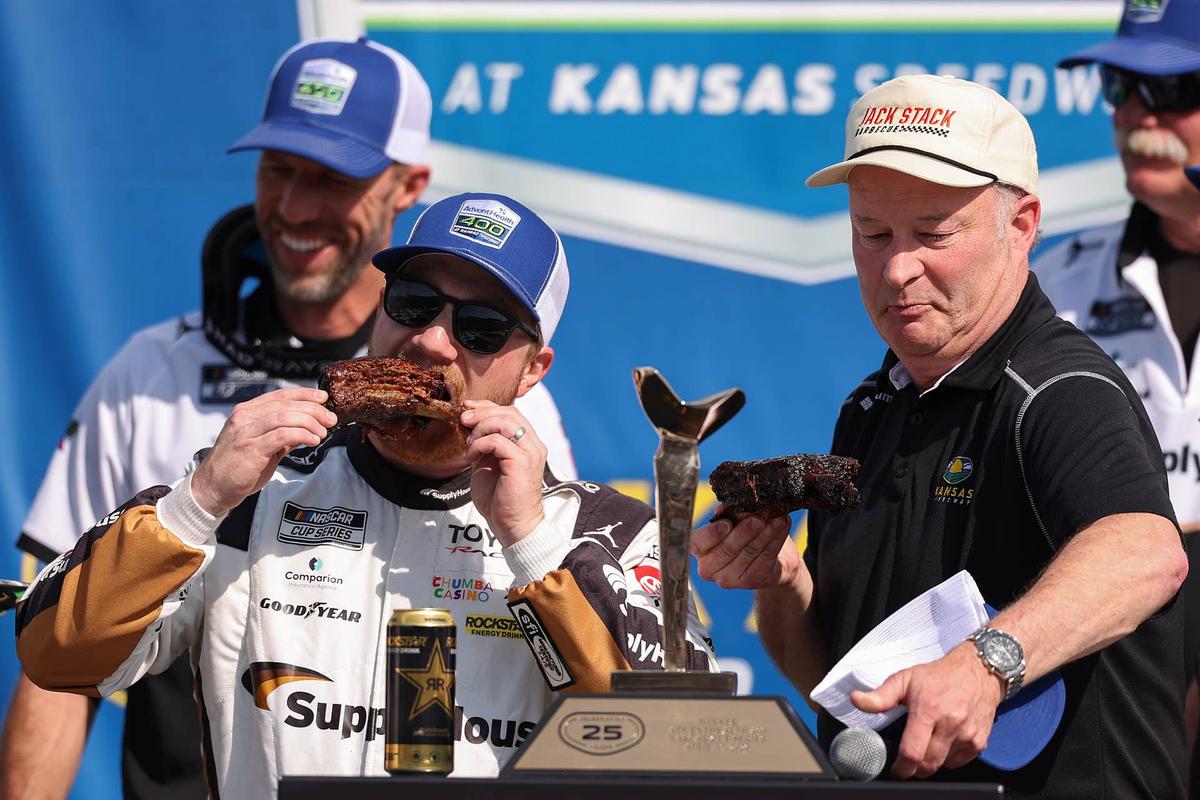  Tyler Reddick celebrates the win at Kansas with ribs in victory lane. (Photo by David Jensen/Getty Images)
