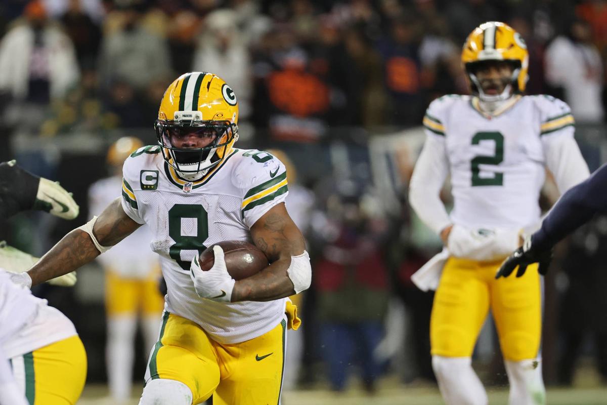  Dec 20, 2025; Chicago, Illinois, USA; Green Bay Packers running back Josh Jacobs (8) runs the ball and quarterback Malik Willis (2) watches the play against the Chicago Bears during the third quarter at Soldier Field. Mandatory Credit: Mike Dinovo-Imagn Images 