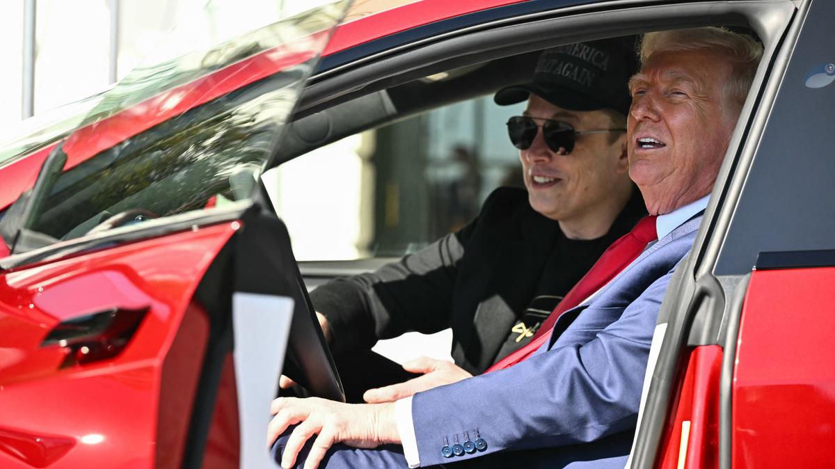 US President Donald Trump and Tesla CEO Elon Musk speak to the press as they sit in a Tesla vehicle on the South Portico of the White House on March 11, 2025 in Washington, DC.