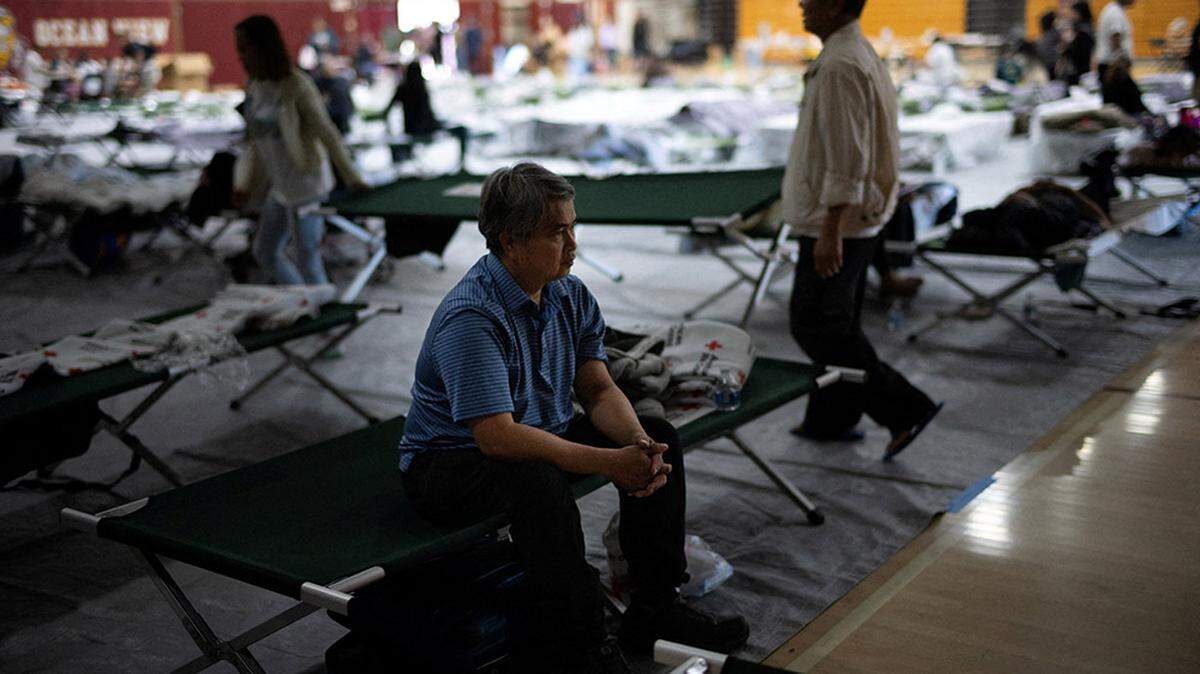 Viwath Taing, 51, who evacuated from Garden Grove, California, sits on a cot at Ocean View High School Gymnasium, which has been turned into a temporary shelter after the threat of an explosion from a failing tank containing a flammable liquid used in the aerospace industry, in Huntington Beach on Saturday. Firefighters on Monday said that a crack relieved some of the mounting pressure, eliminating the possibility of the tank exploding.