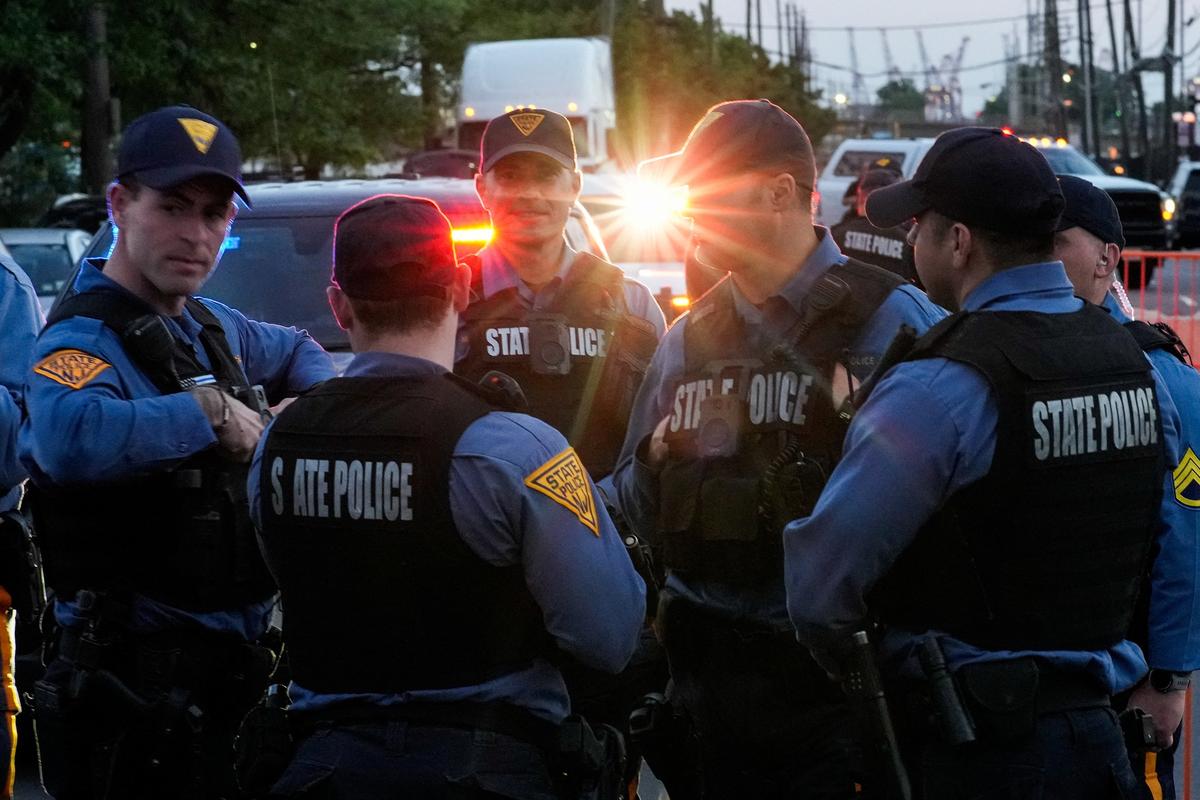 New Jersey State Policemen stand guard as they set up a protest zone outside the Delaney Hall detention center, while demonstrators remain gathered outside, in Newark, New Jersey, U.S., May 29, 2026. REUTERS/Eduardo Munoz