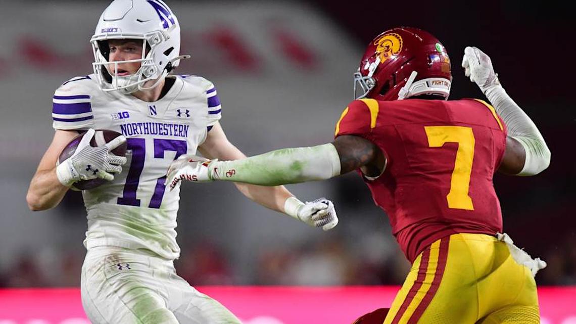  Nov 7, 2025; Los Angeles, California, USA; Northwestern Wildcats wide receiver Griffin Wilde (17) runs the ball against Southern California Trojans safety Kamari Ramsey (7) during the second half at the Los Angeles Memorial Coliseum. Mandatory Credit: Gary A. Vasquez-Imagn Images | Gary A. Vasquez-Imagn Images 