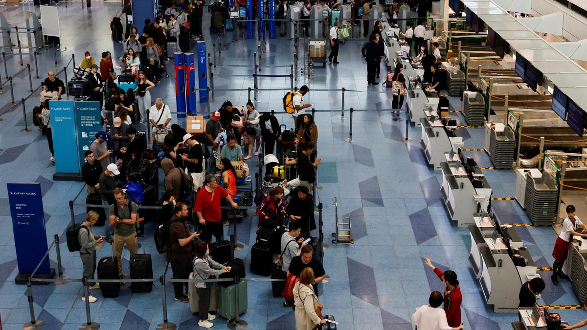 Passengers queue for check-in as Tropical Storm Jangmi disrupts flights at Haneda Airport in Tokyo, Japan, June 3, 2026. REUTERS/Kim Kyung-Hoon