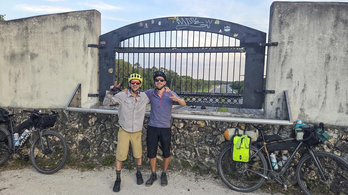 Patrick Connolly and Evan Sanders stop for a photo op on the land bridge that crosses over Interstate 75 during a bikepacking trip on April 18, 2026. (Patrick Connolly/Orlando Sentinel)