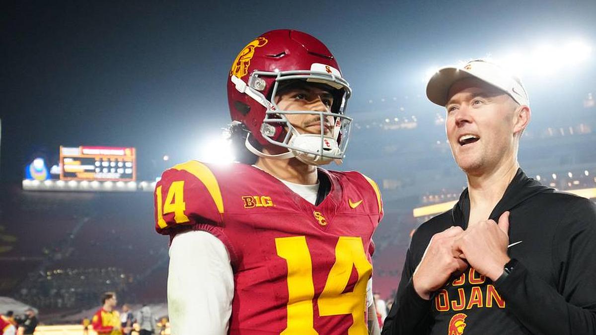  Nov 29, 2025; Los Angeles, California, USA; Southern California Trojans quarterback Jayden Maiava (14) and head coach Lincoln Riley react after the game against the UCLA Bruins at United Airlines Field at Los Angeles Memorial Coliseum. Mandatory Credit: Kirby Lee-Imagn Images | Kirby Lee-Imagn Images 