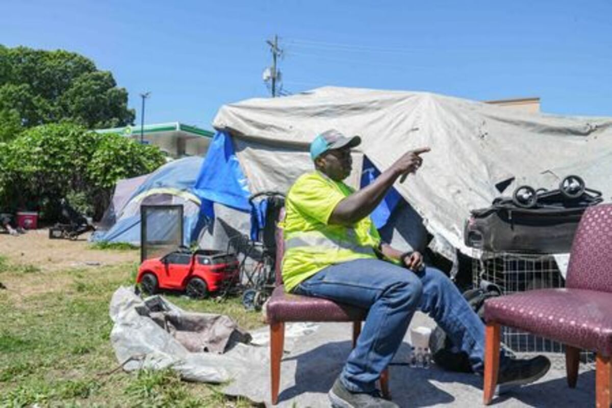 Benjamin Brown, 54, who is currently experiencing homelessness, sits outside of his tent in Atlanta, Georgia, U.S., May 15, 2026.   REUTERS/Megan Varner