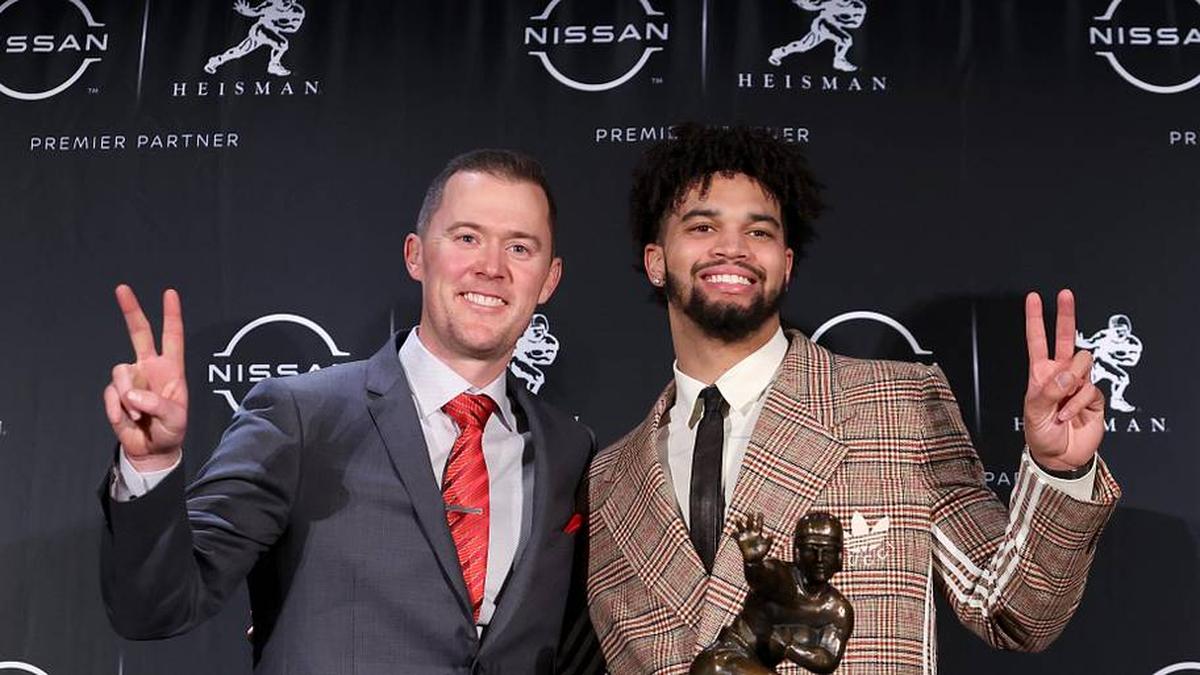  Dec 10, 2022; New York, NY, USA; Southern California quarterback Caleb Williams (right) poses for photos with his head coach Lincoln Riley during a press conference in the Astor Ballroom at the New York Marriott Marquis in New York, NY, after winning the 2022 Heisman Trophy. Mandatory Credit: Brad Penner-Imagn Images | Brad Penner-Imagn Images 