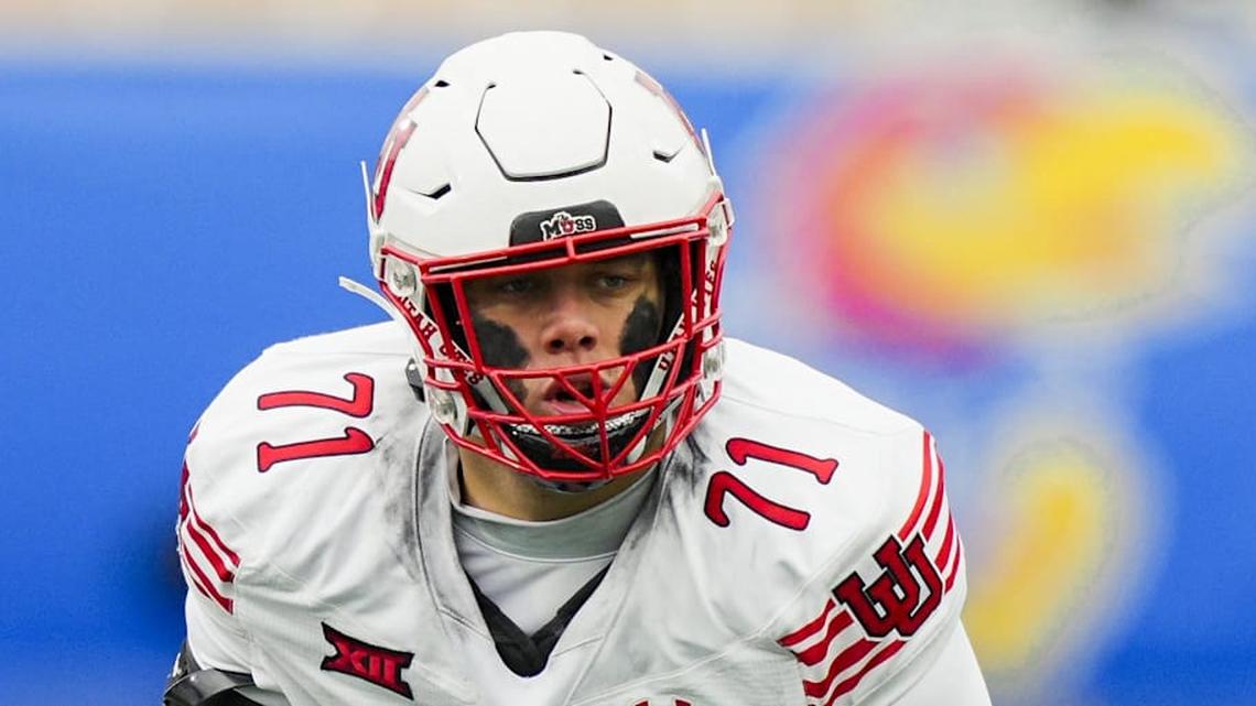  Nov 28, 2025; Lawrence, Kansas, USA; Utah Utes offensive lineman Caleb Lomu (71) gets ready before the snap during the second half against the Kansas Jayhawks at David Booth Kansas Memorial Stadium. Mandatory Credit: Jay Biggerstaff-Imagn Images | Jay Biggerstaff-Imagn Images 