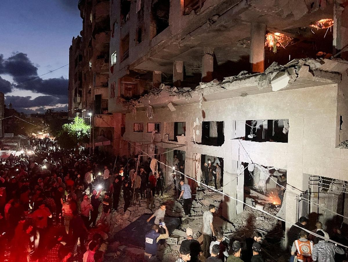 People gather around a residential apartment as a fire burns after Israeli shelling, according to the Ministry of Health, in Gaza City May 15, 2026. REUTERS/Ebrahim Hajjaj