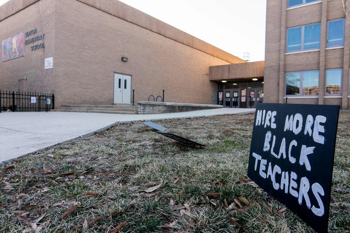  A sign reading ‘Hire More Black Teachers' is displayed in front of an elementary school in Washington in February 2022. Stefani Reynolds/AFP via Getty Images 