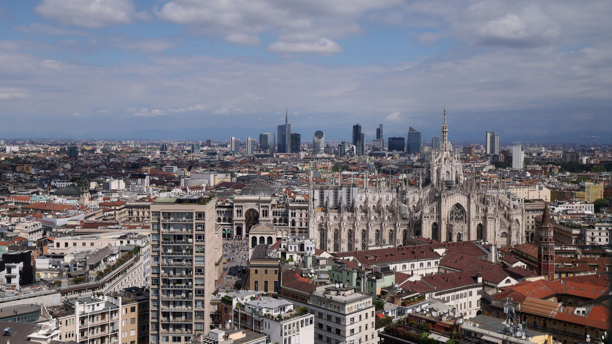A view of Duomo Cathedral and in the background Porta Garibaldi business district, in Milan, Italy, April 22, 2026. REUTERS/Claudia Greco