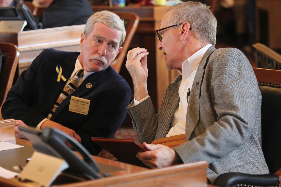Kansas state Reps. Bill Clifford, left, R-Garden City, and Brad Ralph, right, R-Dodge City, confer during a House debate on a bill authorizing sports betting Thursday at the Statehouse in Topeka. Both lawmakers supported the bill, which has passed.