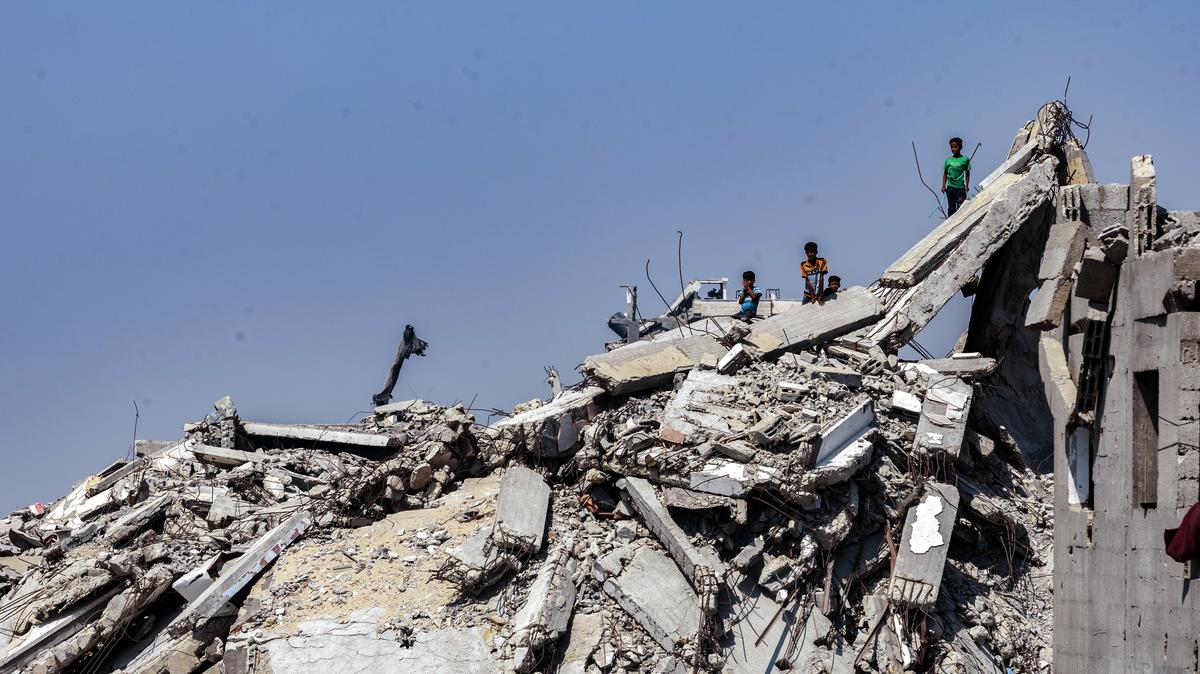Children atop rubble await aid in Gaza City, July 27, 2025. As Gaza tips into famine and images of starving children trigger new demands for action, President Donald Trump faces a test all too familiar to his predecessors.
