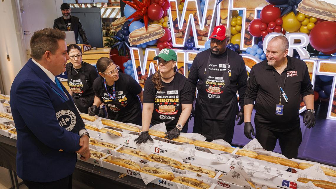Michael Empric, adjudicator with Guinness World Records, inspects the construction of cheesesteaks at Philadelphia International Airport Tuesday, March 24, 2026. (Alejandro A. Alvarez/The Philadelphia Inquirer/TNS)