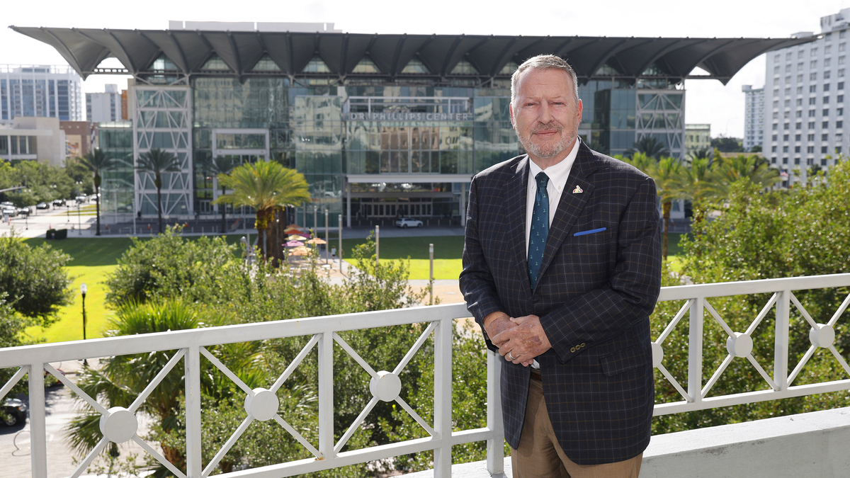 Orlando Mayor Buddy Dyer, shown on the balcony outside his office, remains proud of how the city came together in the massacre’s wake. The yard at the Dr. Phillips Center for the Performing Arts, seen in the background, served as a primary gathering space for the community to mourn. (Ricardo Ramirez Buxeda/Orlando Sentinel/TNS)