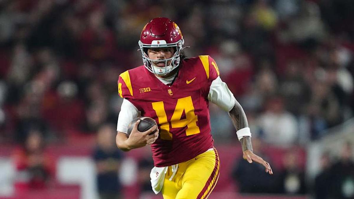  Nov 29, 2025; Los Angeles, California, USA; Southern California Trojans quarterback Jayden Maiava (14) carries the ball against the UCLA Bruins in the first half at United Airlines Field at Los Angeles Memorial Coliseum. Mandatory Credit: Kirby Lee-Imagn Images | Kirby Lee-Imagn Images 