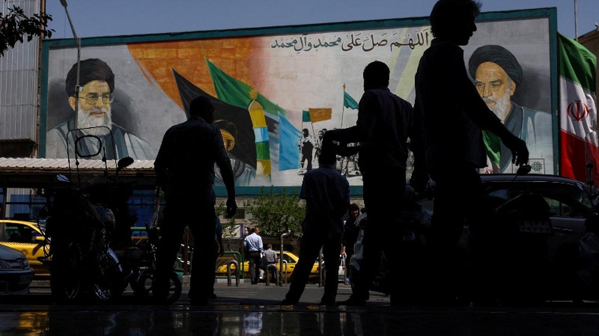 People walk past a mural depicting the late leader of the Islamic Revolution, Ayatollah Ruhollah Khomeini, and the late Iran's Supreme Leader Ayatollah Ali Khamenei, in Tehran, Iran, May 12, 2026. Majid Asgaripour/WANA (West Asia News Agency) via REUTERS