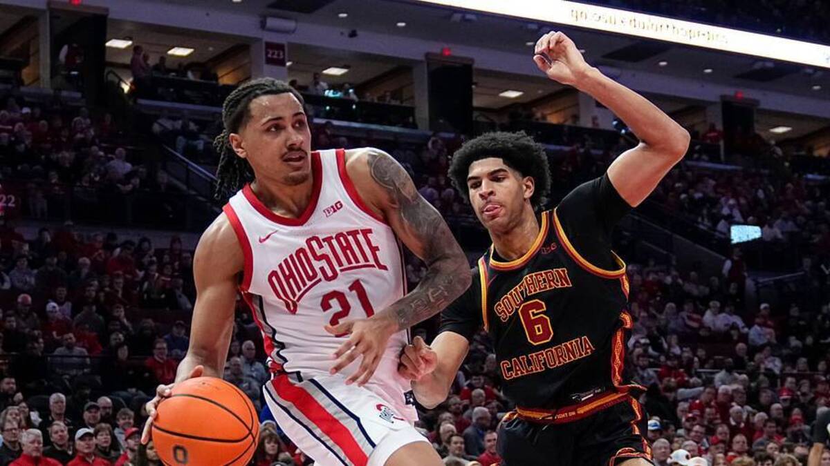 Ohio State Buckeyes forward Devin Royal (21) looks to pass around USC Trojans forward Jacob Cofie (6) during the first half of the NCAA men's basketball game at the Schottenstein Center on Feb. 11, 2026. | Adam Cairns/Columbus Dispatch / USA TODAY NETWORK via Imagn Images 