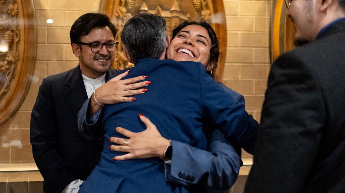 Independent potential candidates Lindsay Church, second from left, and Mayra Macias embrace during a forum for the 4th Congressional District seat held at the University of Illinois Chicago on April 29, 2026. Ald. Byron Sigcho-Lopez, 25th, stands behind on left. (Josh Boland/Chicago Tribune/TNS)