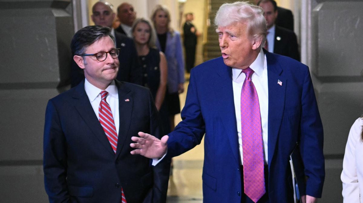 President Donald Trump, joined by US Speaker of the House Mike Johnson, speaks to reporters as he arrives for a House Republican meeting at the Capitol in Washington, DC on May 20, 2025.