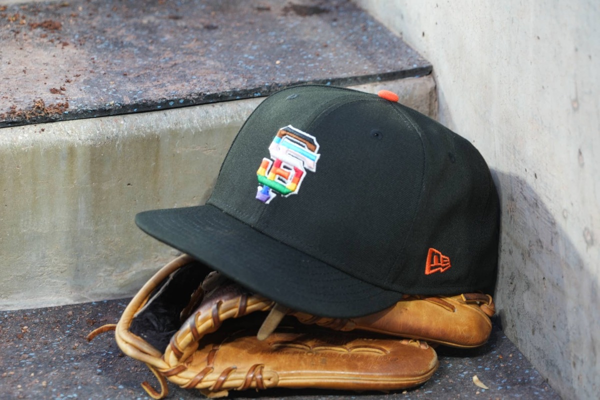  Jun 16, 2023; Los Angeles, California, USA; A rainbow colored San Francisco Giants logo cap and a glove in the dugout during LGBTQ+ Pride Night at Dodger Stadium at Dodger Stadium. Mandatory Credit: Kirby Lee-USA TODAY Sports 