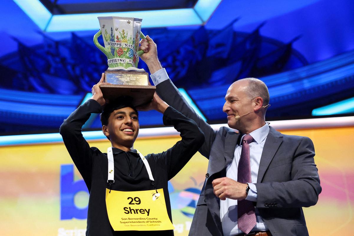 Shrey Parikh lifts the trophy after winning the annual Scripps National Spelling Bee with "cashaw" as his winning word in Washington, D.C., U.S., May 28, 2026. REUTERS/Kevin Lamarque