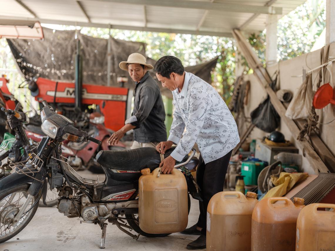 **EMBARGO: No electronic distribution, Web posting or street sales before MONDAY 5:01 A.M. ET APRIL 27, 2026. No exceptions for any reasons. EMBARGO set by source.** FILE -- A farmer prepares plastic containers of diesel he just purchased in the Dong Thap Province of Vietnam, March 25, 2026. The fallout from two months of war in Iran is shuttering textile mills in India and Bangladesh, grounding airplanes in Ireland, Poland and Germany, and prompting energy rationing in Vietnam, South Korea and Thailand. (Linh Pham/The New York Times)