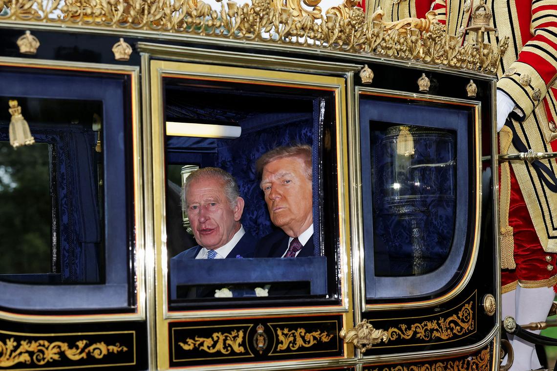 King Charles III and U.S. President Donald Trump sit in a carriage during a procession through Windsor Castle during the state visit by the President of the United States of America on September 17, 2025 in Windsor, England.