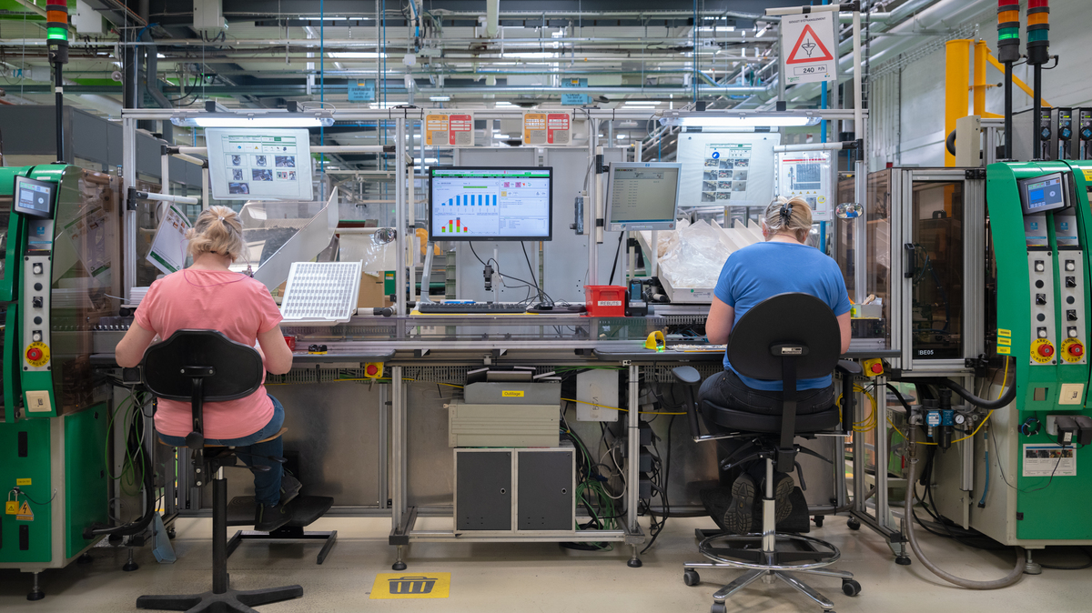 Workers assemble components at a Schneider Electric factory in La Vaudreuil, France on May 6, 2026. The French multinational decided to use artificial intelligence in manufacturing to make workers more productive, rather than to replace them.