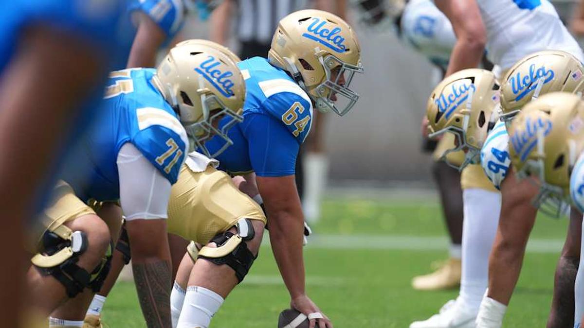  May 2, 2026; Pasadena, CA, USA; A general overall view of helmets at the line of scrimmage as UCLA Bruins center Sam Yoon (64) snaps the ball during the spring game at Rose Bowl. Mandatory Credit: Kirby Lee-Imagn Images | Kirby Lee-Imagn Images 